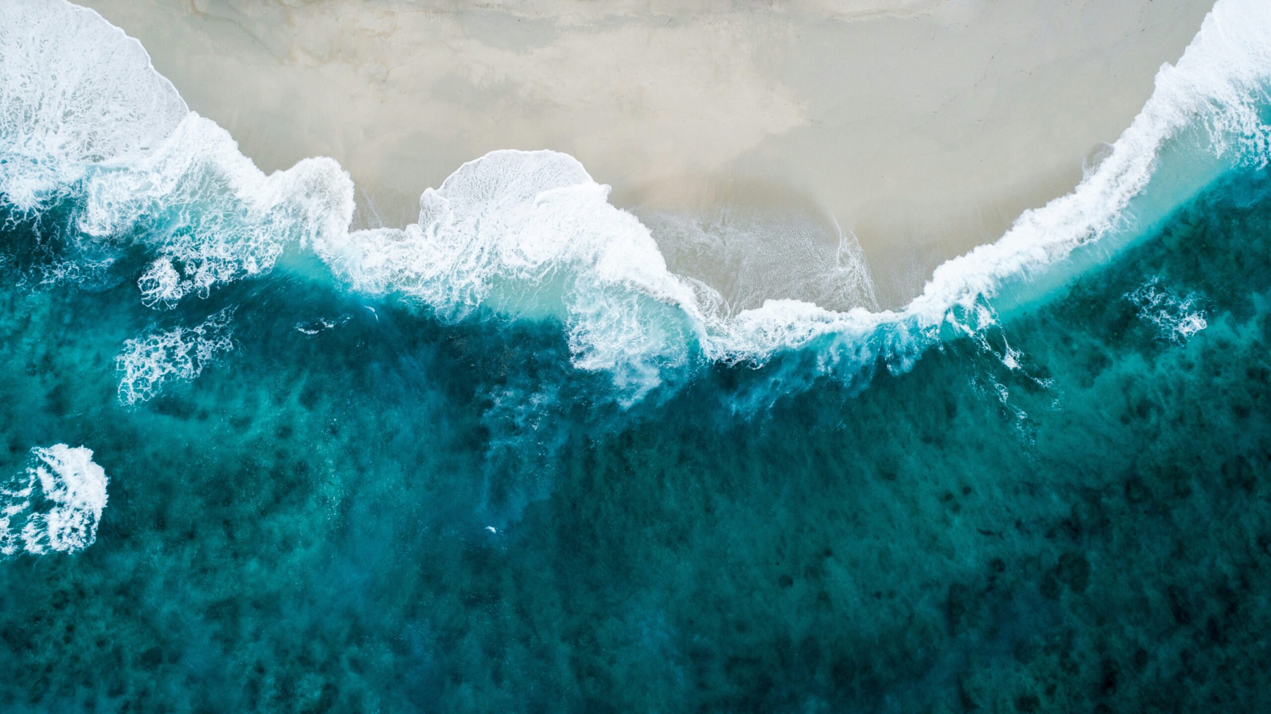 blue ocean from above - shoreline with beach break and waves - Birte Rommeswinkel Strategic Marketing PMO - Pic-by-shifaaz-shamoon-sLAk1guBG90-unsplash-scaled