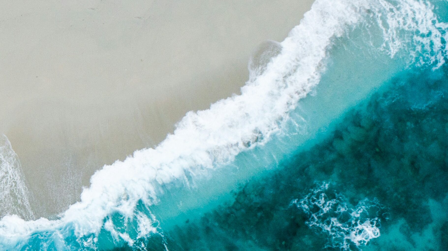 blue ocean from above - shoreline with breach and waves - Birte Rommeswinkel - Pic-by-shifaaz-shamoon-sLAk1guBG90-unsplash-scaled